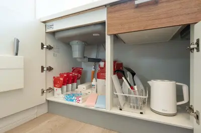 a cupboard filled with lots of products in a kitchen at Kisa in Tokyo