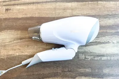 a hair dryer sitting on top of a wooden table at \u30a8\u30ec\u30ac\u30f3\u30c8\u30cf\u30a6\u30b9 in Tokyo