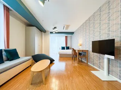 a living room with a couch and a flat screen tv at \u30b3\u30b9\u30e2\u30ea\u30fc\u30c9\u5357\u9ebb\u5e03 in Tokyo