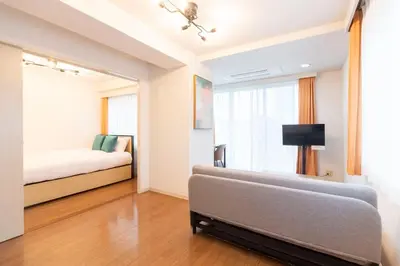 a living room with a couch and a window at \u30b3\u30b9\u30e2\u30ea\u30fc\u30c9\u5357\u9ebb\u5e03 in Tokyo