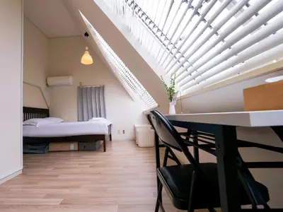 a room with a bed and a table and chairs at 7\u6642IN19\u6642OUT # \u65b0\u5bbf\u99c5\u96fb\u8eca4\u5206 # \u99c58\u5206 # \u65b0\u898f\u30ea\u30ce\u30d9\u30fc\u30b7\u30e7\u30f3 # \u6700\u59275\u540d # \u5c02\u7528\u30d0\u30b9\u30ad\u30c3\u30c1\u30f3 # 7 00 IN19 00 OUT # 4 min train to Shinjuku # 8 min walk to station # Newly renovated # Max 5 guests # Private bath kitchen in Tokyo