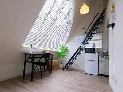 a kitchen with a table and a refrigerator and a large window at 7\u6642IN19\u6642OUT # \u65b0\u5bbf\u99c5\u96fb\u8eca4\u5206 # \u99c58\u5206 # \u65b0\u898f\u30ea\u30ce\u30d9\u30fc\u30b7\u30e7\u30f3 # \u6700\u59275\u540d # \u5c02\u7528\u30d0\u30b9\u30ad\u30c3\u30c1\u30f3 # 7 00 IN19 00 OUT # 4 min train to Shinjuku # 8 min walk to station # Newly renovated # Max 5 guests # Private bath kitchen in Tokyo