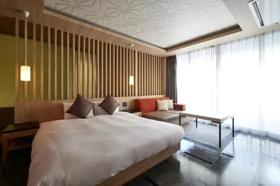 a bedroom with a large bed and a couch at ALFIT HOTEL & BAR AKASAKA in Tokyo