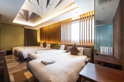 a hotel room with three beds and a table at ALFIT HOTEL & BAR AKASAKA in Tokyo