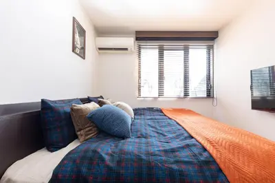 a bedroom with a bed and a window at Shibuya-ku - Apartment - Vacation STAY 72295v in Tokyo