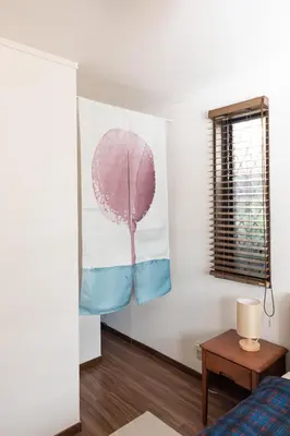 a bedroom with a pink tree painting on the wall at Shibuya-ku - Apartment - Vacation STAY 72295v in Tokyo