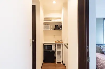 a small room with a kitchen with a microwave at Shibuya-ku - Apartment - Vacation STAY 67815v in Tokyo