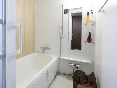 a white bathroom with a sink and a mirror at Onyado Nono Asakusa Annex - Natural Hot Spring in Tokyo