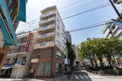 a tall apartment building on a city street at Azabukumai building in Tokyo