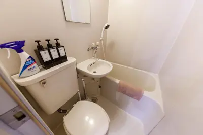 a small bathroom with a toilet and a sink at Azabukumai building in Tokyo