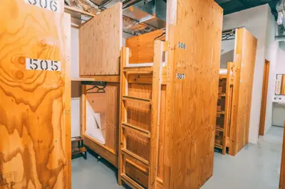 a room with several wooden bunk beds in a room at Tokyo Guesthouse HIVE in Tokyo