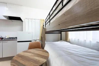a bedroom with a bed and a wooden table at \u30d1\u30a4\u30f3\u30b3\u30fc\u30c8 in Tokyo