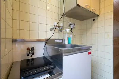 a kitchen with a sink and a stove at \u30d1\u30ed\u9577\u5d0e in Tokyo