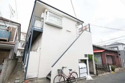 a bike parked next to a white building at \u30d1\u30ed\u9577\u5d0e in Tokyo