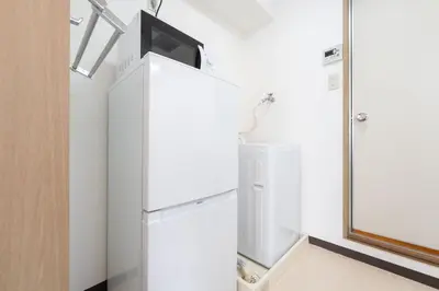a white refrigerator with a tv on top of it at \u30e9\u30a4\u30ef\u30de\u30f3\u30b7\u30e7\u30f3\u5357\u9ebb\u5e03 in Tokyo