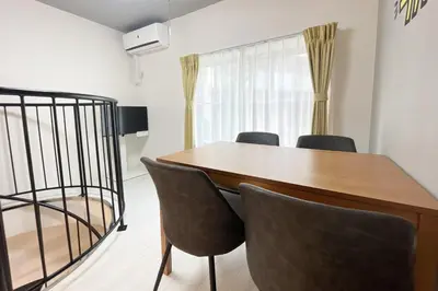 a dining room with a table and chairs at \u30e9\u30eb\u30fc\u30ca\u6771\u6c60\u888b in Tokyo