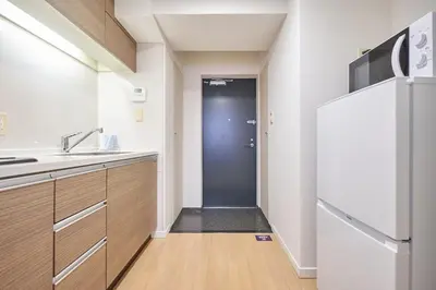 a kitchen with a refrigerator and a sink at \u30eb\u30fc\u30c1\u30a7\u9ad8\u8f2a in Tokyo