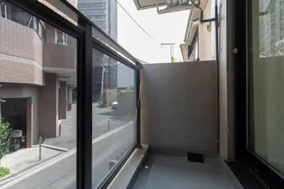 an open window with a view of a city street at \u30ec\u30d4\u30e5\u30a2\u6771\u5411\u5cf6\u99c5\u524d\u30ec\u30b8\u30c7\u30f3\u30b9ll in Tokyo