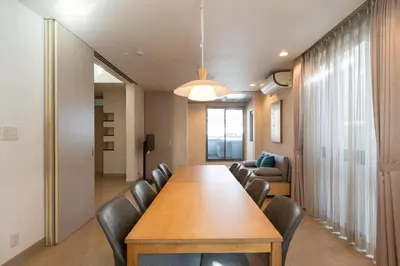 a conference room with a wooden table and leather chairs at \u6771\u99d2\u5f622\u4e01\u76ee\u6238\u5efa in Tokyo