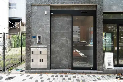 a door to a building with a kitchen inside at KAIGAN HAJIME Hub in Tokyo