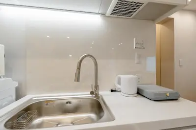 a kitchen with a sink and a toaster on a counter at The Monica Residence ShinjukuGyoen in Tokyo