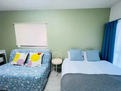 a bedroom with two beds with blue and yellow pillows at Okubo abia house-SJ0155 in Tokyo