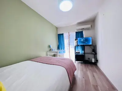 a bedroom with a bed and a flat screen tv at Okubo abia house-SJ0155 in Tokyo
