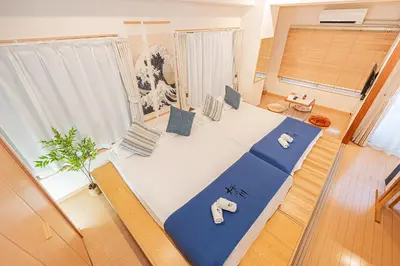 a room with a large bed with two elephants on it at \u685c\u306e\u5ddd 3\u4e28\u6b65\u884c 5 \u5206 \u5de3\u9d28\u99c5 JR \u7ebf 2-8 \u4eba \u65e5\u5f0f\u516c\u5bd3\u4e285-Min Walk to Sugamo JR Line 2-8 Guests Japanese Home in Tokyo