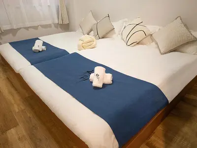 a bed with two pillows on top of it at \u685c\u306e\u5ddd 3\u4e28\u6b65\u884c 5 \u5206 \u5de3\u9d28\u99c5 JR \u7ebf 2-8 \u4eba \u65e5\u5f0f\u516c\u5bd3\u4e285-Min Walk to Sugamo JR Line 2-8 Guests Japanese Home in Tokyo