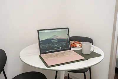 a laptop computer sitting on a table with a plate of food at ZAITO Kikukawa SRS Apartment \u65b0\u7bc9\u30de\u30f3\u30b7\u30e7\u30f3 in Tokyo