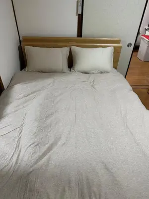 a large bed with white sheets and pillows at \u6c34\u4ed9 Kamata in Tokyo