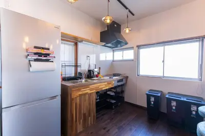 a kitchen with a white refrigerator and a sink at \u548c\u6c23\u4f1a\u3005\u65b0\u5927\u4e45\u4fdd Wakiaiai Shinokubo in Tokyo