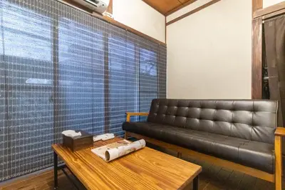 a living room with a leather couch and a table at \u548c\u6c23\u4f1a\u3005\u65b0\u5927\u4e45\u4fdd Wakiaiai Shinokubo in Tokyo