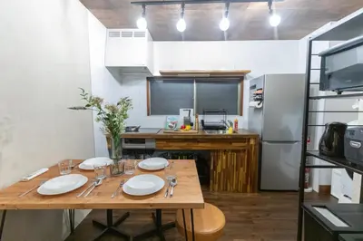 a kitchen with a wooden table with plates on it at \u548c\u6c23\u4f1a\u3005\u65b0\u5927\u4e45\u4fdd Wakiaiai Shinokubo in Tokyo