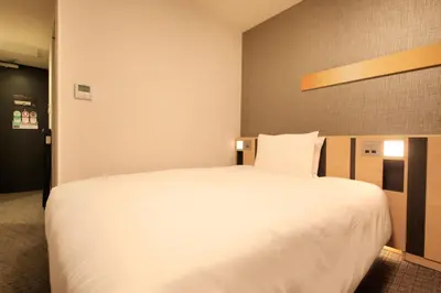 a large white bed in a hotel room at Richmond Hotel Tokyo Suidobashi in Tokyo