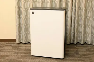 a white refrigerator sitting in front of a curtain at Richmond Hotel Tokyo Suidobashi in Tokyo