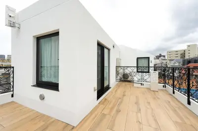 a balcony with white walls and black windows at D-WASEDA in Tokyo