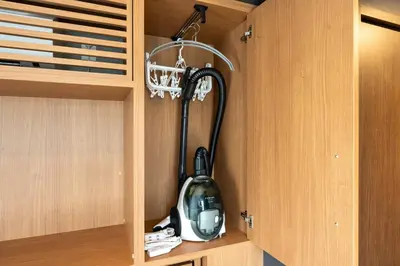 a vacuum cleaner in a cabinet in a kitchen at D-WASEDA in Tokyo