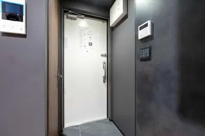 a door in a room with a sign on the wall at D-WASEDA in Tokyo