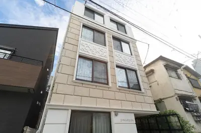 a tall building with windows on the side of it at D-WASEDA in Tokyo
