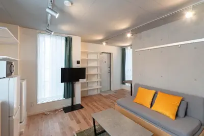 a living room with a couch and a tv in it at \u30a2\u30d4\u30c1\u30a7\u738b\u5b50 in Tokyo