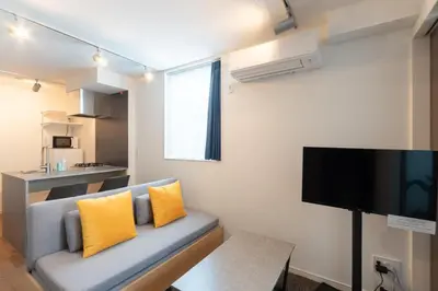 a living room with a couch and a flat screen tv at \u30a2\u30d4\u30c1\u30a7\u738b\u5b50 in Tokyo