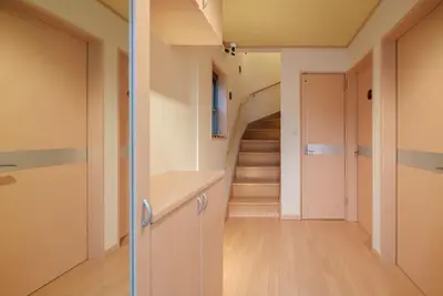 a hallway with a staircase in a house at 匯家•平和島ビル in Tokyo