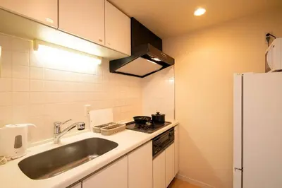 a small kitchen with a sink and a refrigerator at Elegant Condominium Kinshicho in Tokyo