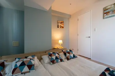 a bedroom with a bed with pillows on it at Elegant Condominium Kinshicho in Tokyo