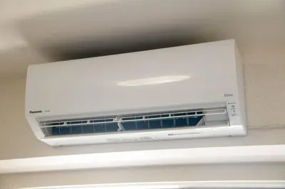 a white microwave oven hanging from a ceiling at Elegant Condominium Kinshicho in Tokyo