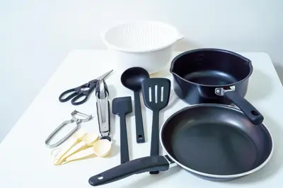 a frying pan and other kitchen utensils on a table at Green Sea Oshiage 5F in Tokyo