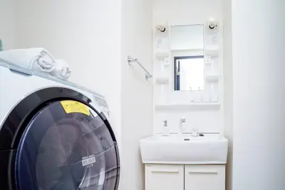 a washing machine in a bathroom with a sink at Green Sea Oshiage 5F in Tokyo