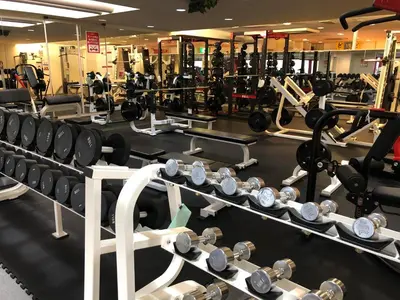 a gym filled with lots of dumbbell machines at Men Only Capsule Room & Sauna, Bathhouse, gim 男性専用サウナ&カプセル Minami Gakugeidai in Tokyo