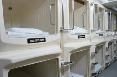 a row of white sinks in a train at Men Only Capsule Room & Sauna, Bathhouse, gim 男性専用サウナ&カプセル Minami Gakugeidai in Tokyo